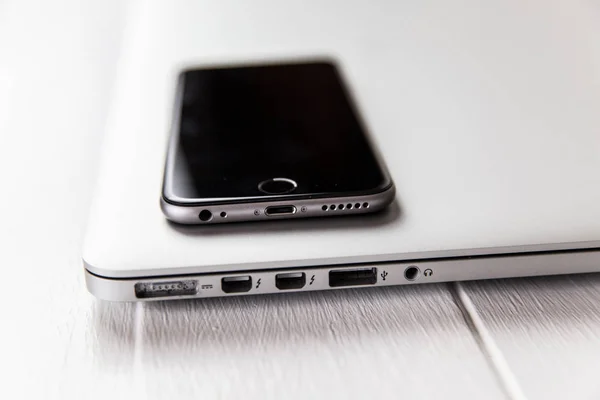 Laptop e telefone celular na mesa — Fotografia de Stock