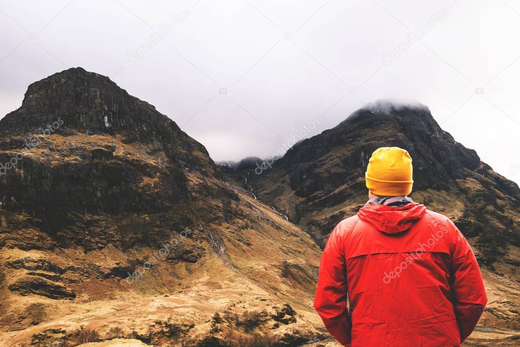 Man standing in cloudy mountains