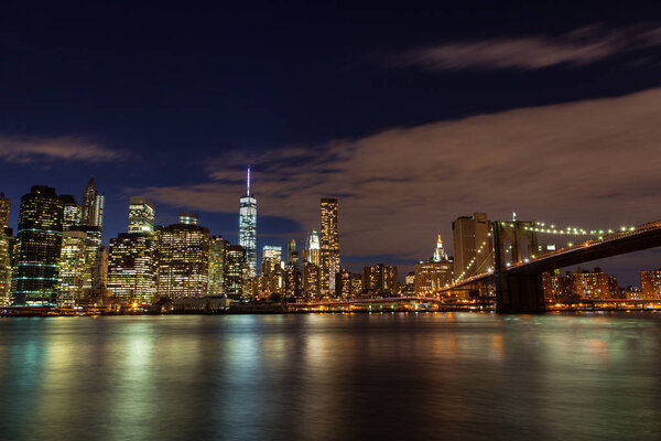 Brooklyn Bridge on Manhattan skyline at night in New York City