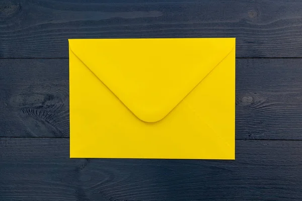 Bright yellow envelope on  table — Stock Photo, Image