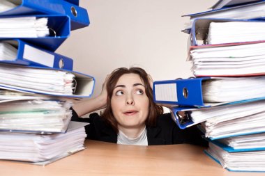 Stressed businesswoman with stack of folders clipart