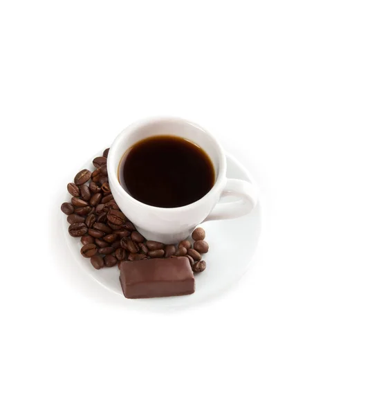 Una tazza di caffè, caramelle al cioccolato e semi — Foto Stock