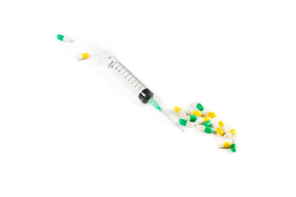 Obrázek barevné tablety a injekční stříkačka — Stock fotografie