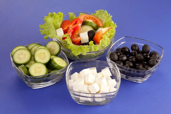 Picture of plates with greek salad and ingridients — Stock Photo, Image