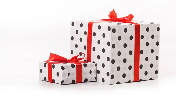 White gift boxes with red ribbon bow, isolated on white — Stock Photo, Image