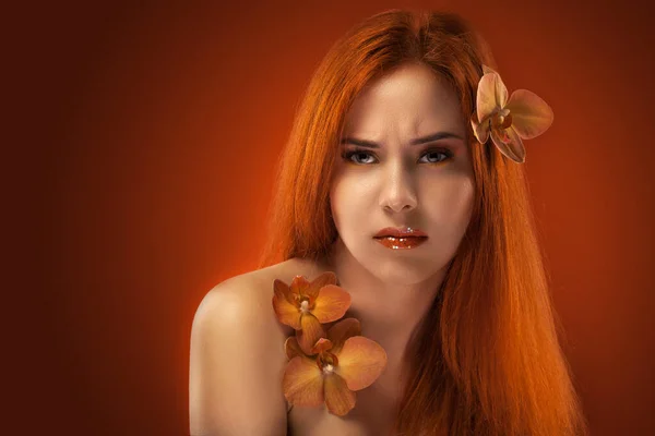 Beauty womans portrait. evening make-up on the orange bokeh background — Stock Photo, Image