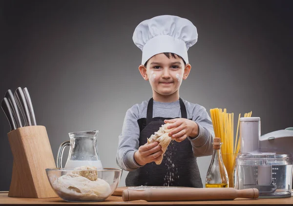 Boy Chef Cooking on a gray background. — Stock Photo, Image