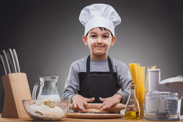 Boy Chef Cooking on a gray background. — Stock Photo, Image