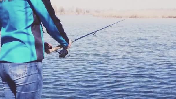Linda mujer está pescando con caña en el lago — Vídeo de stock