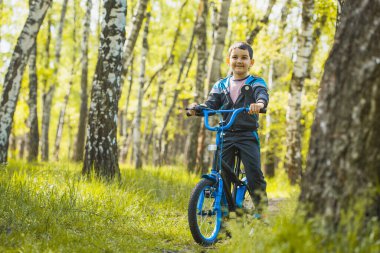 Ormanda bisikletle gezen mutlu çocuk..