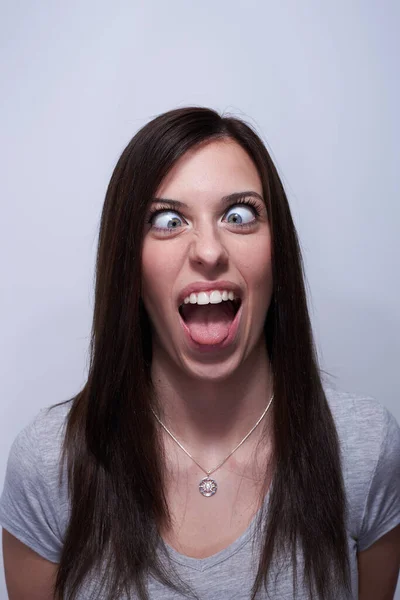 Portrait of a crossed eye woman making silly faces — Stock Photo, Image