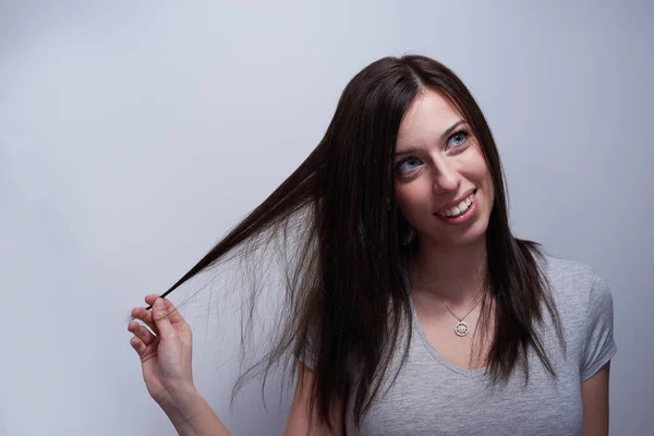 Portrait of a woman touching her hair like if it's damaged — Stock Photo, Image