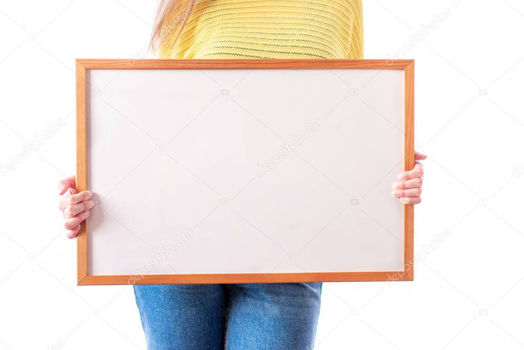 Woman holding a white sign, ideal template for mockups, written phrases or drawings