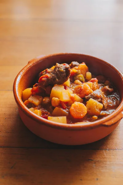 potatoes and meat stew on a clay container