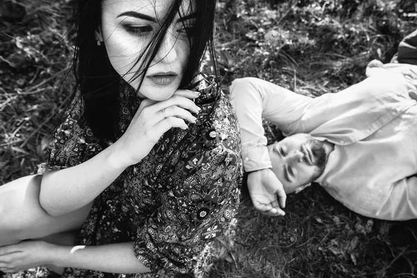 Young couple in the blooming garden — Stock Photo, Image