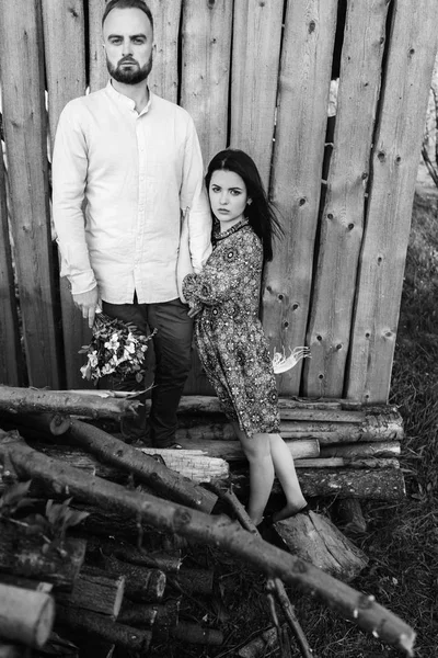 Young couple near an old wooden house