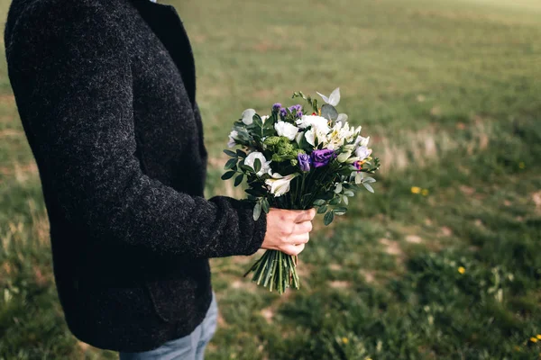 Young man with bouquet