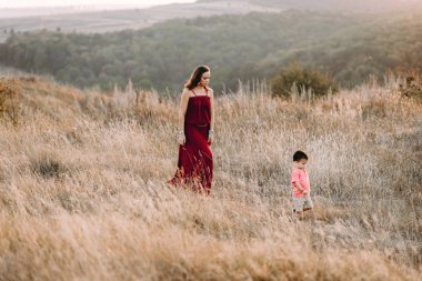 Anne ile oğlu yüksek çim yürür