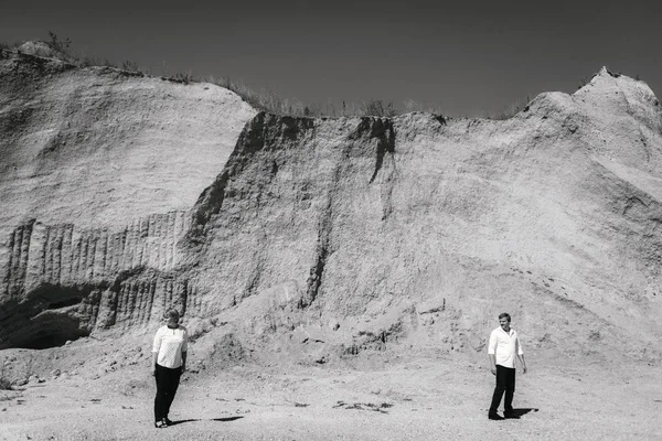 middle-aged couple walks near the cliffs