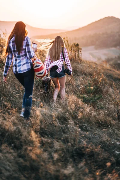 Beautiful girls with bags in mountains — Stock Photo, Image