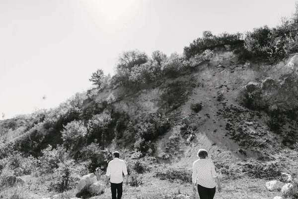 middle-aged couple walks near the cliffs