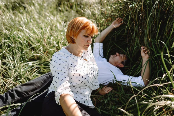 Casal de meia-idade descansando perto do rio — Fotografia de Stock