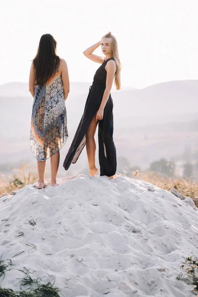 Beautiful girls walking on sand — Stock Photo, Image