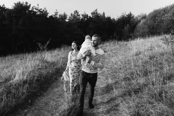 Familia joven con hija caminando en las montañas — Foto de Stock
