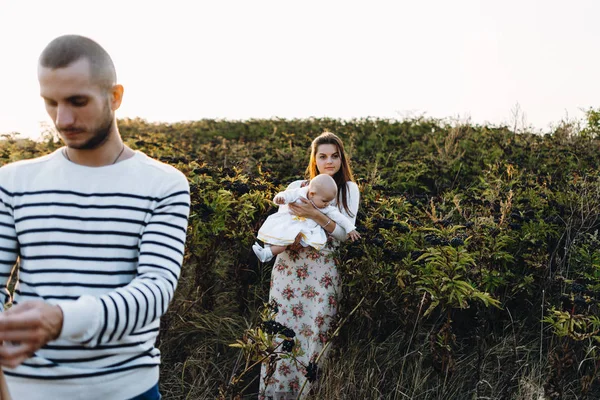 Familia joven con hija caminando en las montañas — Foto de Stock