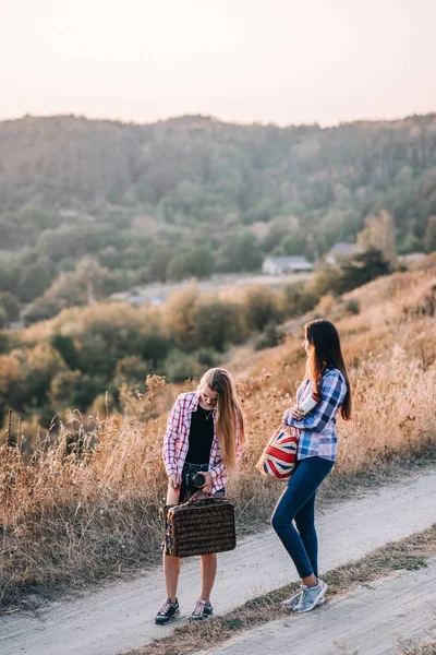 Beautiful girls with bags in mountains — Stock Photo, Image