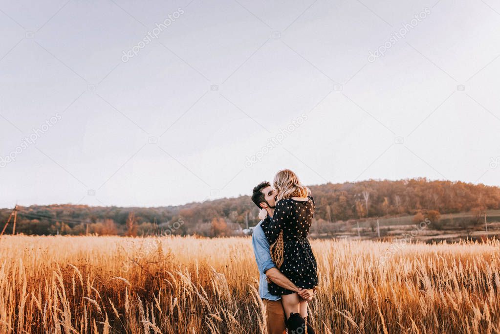 Couple embracing in wheat field