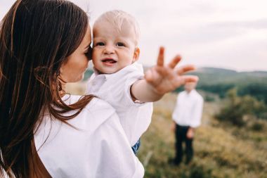 Genç aile çayırda yürüyüş