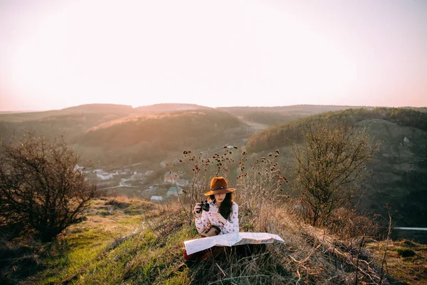 Traveler girl in mountains at sunset