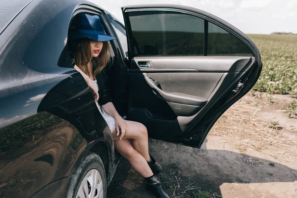 woman sitting on backseat of car