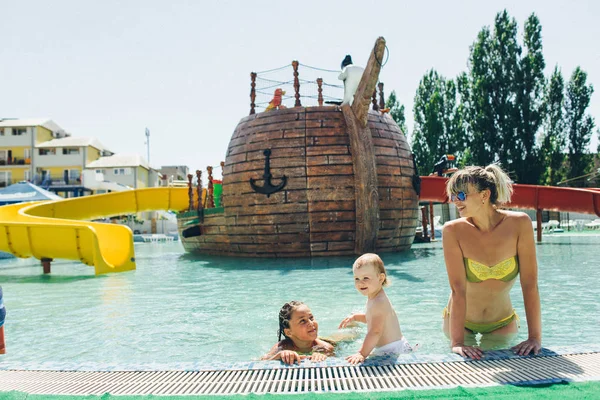 daughters and mother in aqua park