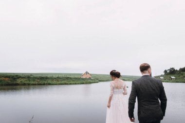 Yeni evliler göl kenarında Evlendikleri gün yürümek.