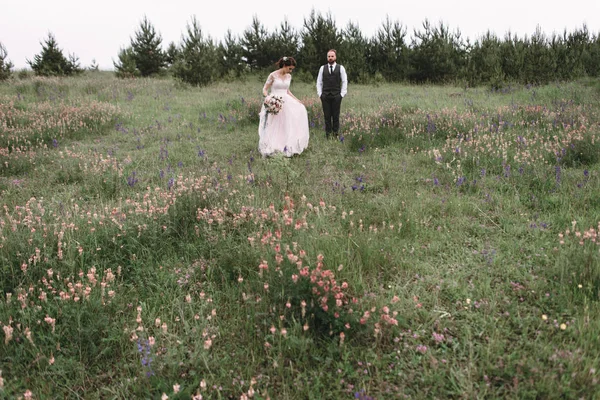 Nygifta promenad utomhus på deras bröllopsdag — Stockfoto