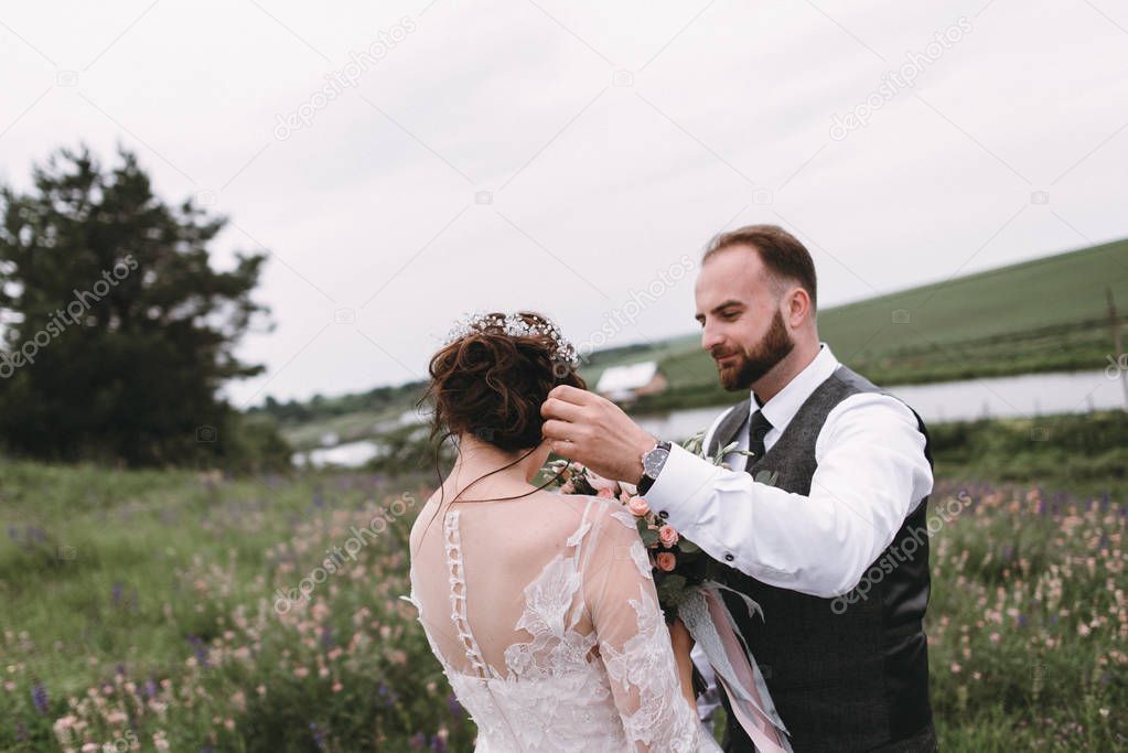 Newlyweds walk outdoors on their wedding day