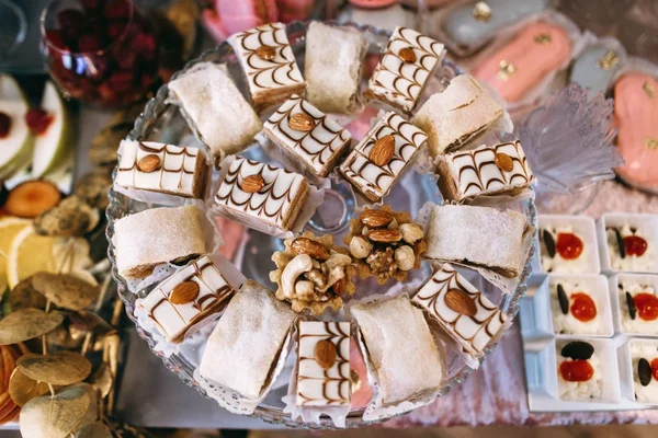 Wedding sweet table with desserts and cakes. A beautiful wedding reception