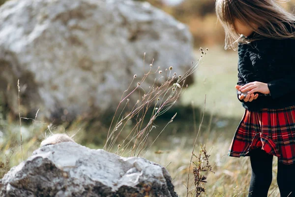 View Girl Wearing Bright Checkered Skirt Black Jumper Holding Stone — Stock Photo, Image