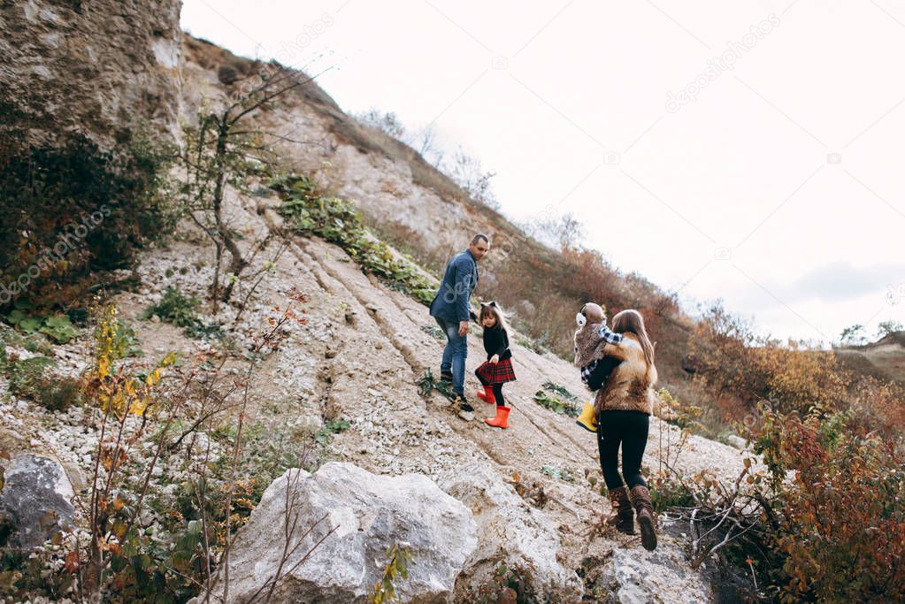 Family walking outside and climbing on hill