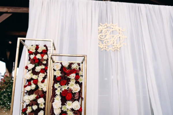 VIew of flower decoration and photo zone with initials of newlyweds