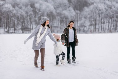 Kar kış park arka plan üzerinde çalışan aile yan görünüm