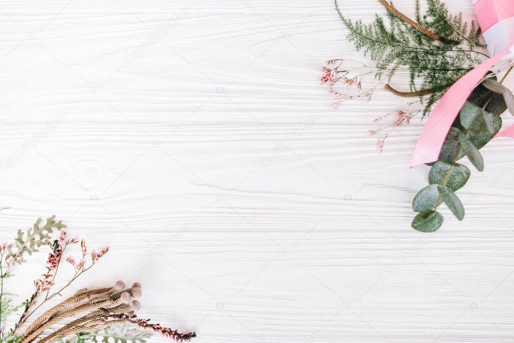 Floral bouquets with white gift box on white wooden background