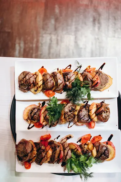 Gegrilltes Fleisch Kartoffeln Und Tomaten Auf Weißen Langen Rechteckigen Tellern — Stockfoto