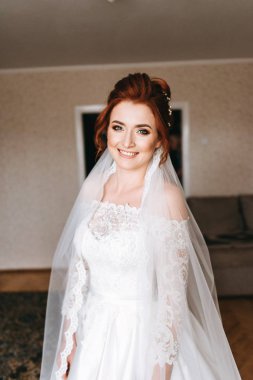 Gülümseyen ve oturma odasında poz şirin Kızıl saçlı gelin