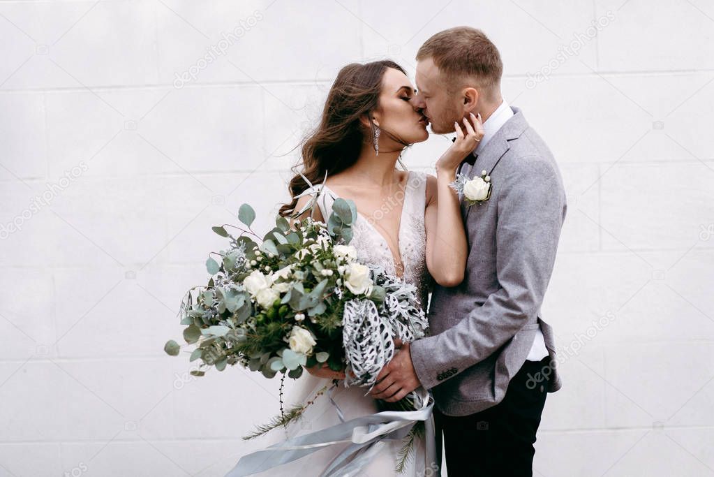 Closeup of lovely newlyweds kissing in garden