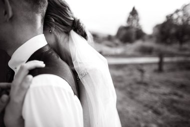 Closeup portrait of newlyweds posing together outdoors