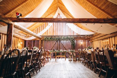 Festive dining room in rustic style decorated  with white flowers