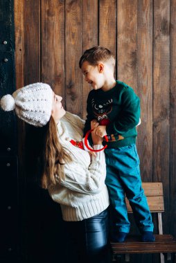 Woman in knitted outfit enjoying time with small boy